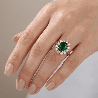 Anillo de oro rosa con diamantes y esmeraldas en halo, ajustable, de la marca Rose & Oliver, detalle de joya elegante y sofisticada.