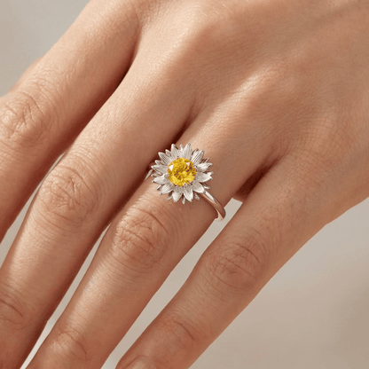 Anel ajustável com design de girassol dourado da marca Rose & Oliver, detalhe de flor de girassol em prata brilhante.