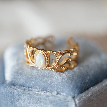 Anillo ajustable Rose Gold Opal Alas Celestiales de Rose & Oliver, con detalles de alas y piedra de ópalo brillante.