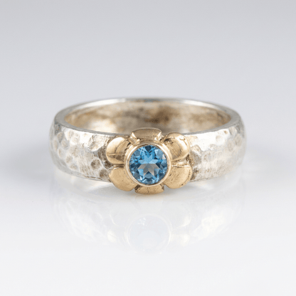 Anillo de plata de dos tonos con topacio azul hecho a mano, de la marca Rose & Oliver, mostrado en la imagen.